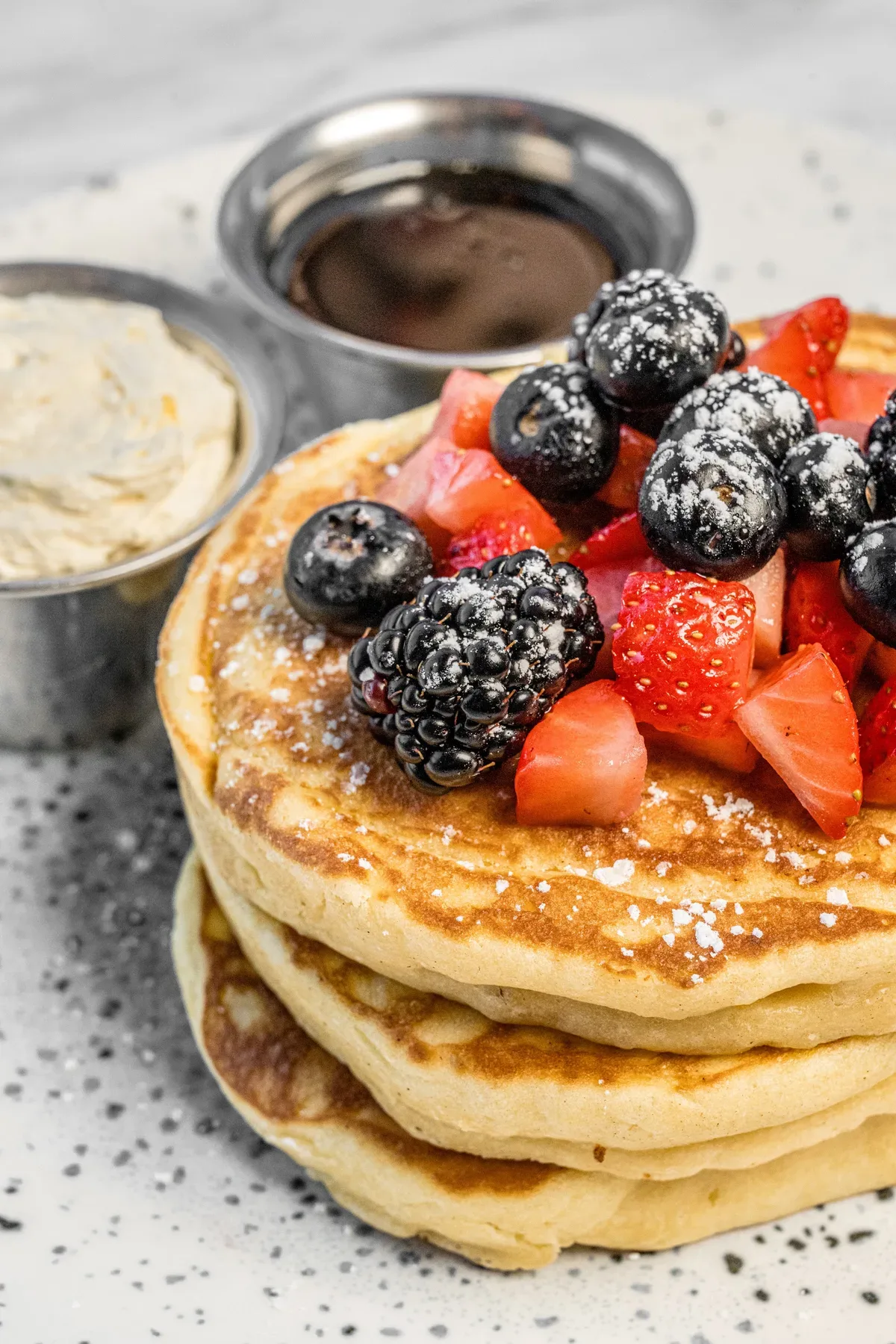 Madison & Heig pancakes with berries on a marble table