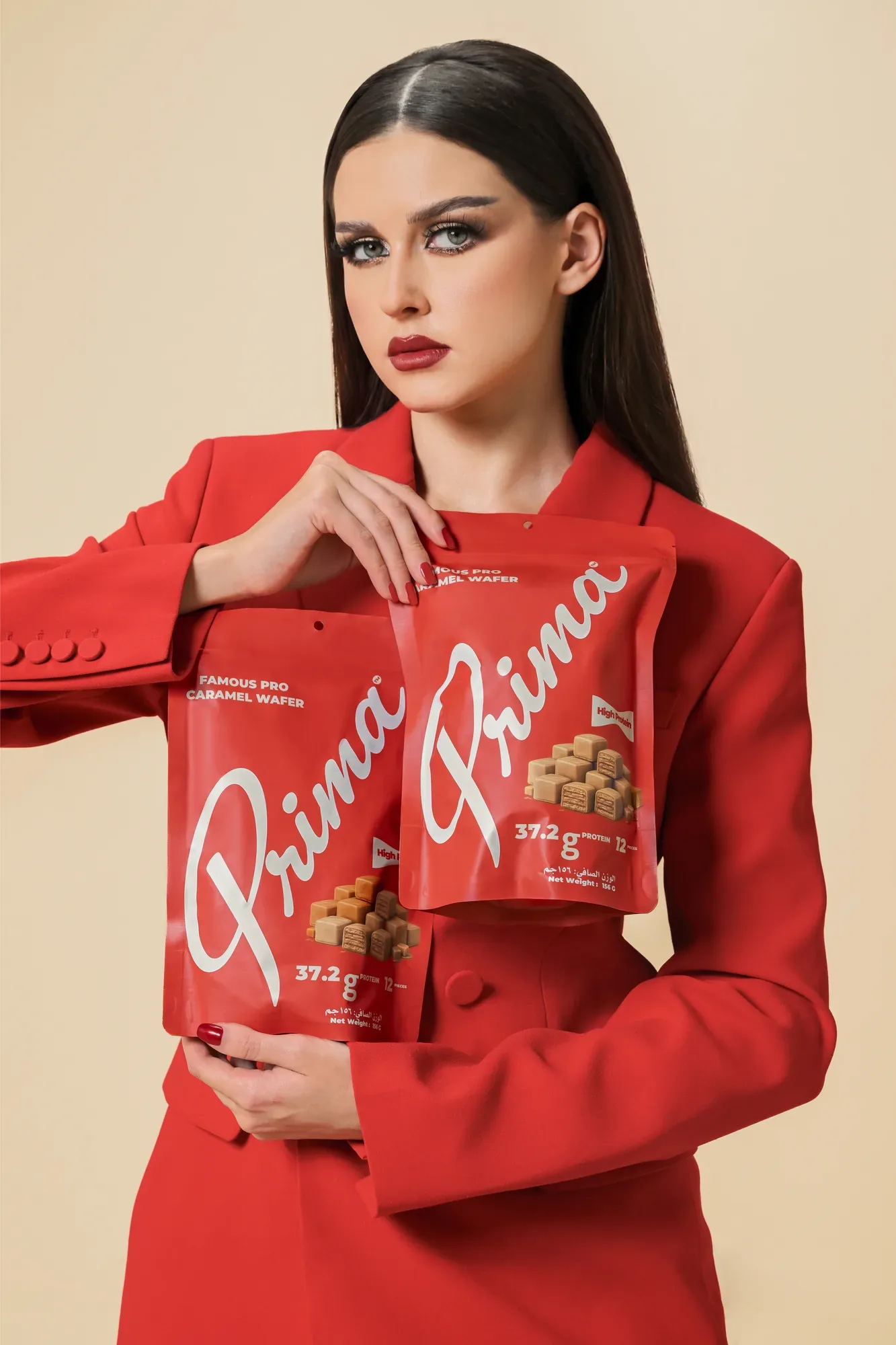 Prima campaign portrait in red holding two pouches